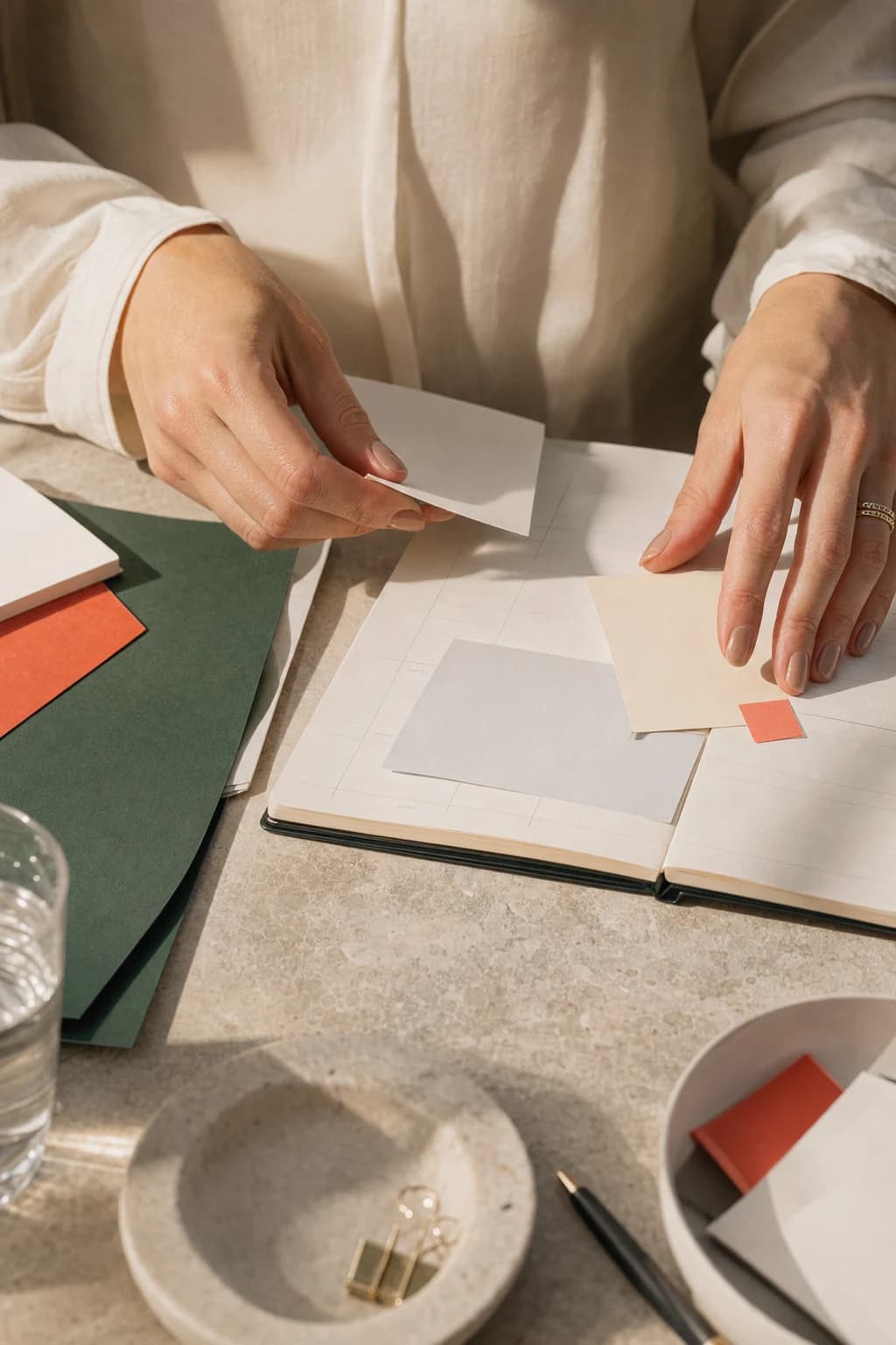 Hands arranging paper notes on a weekly planner